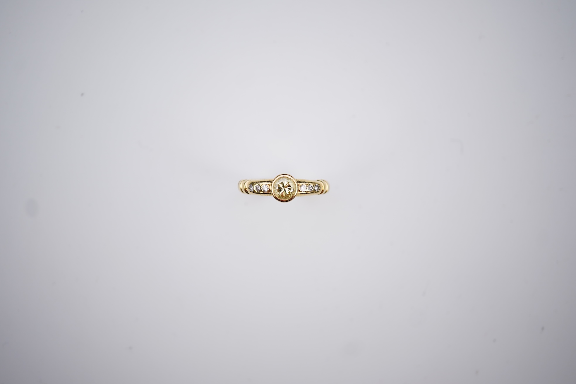 A yellow diamond and diamond ring